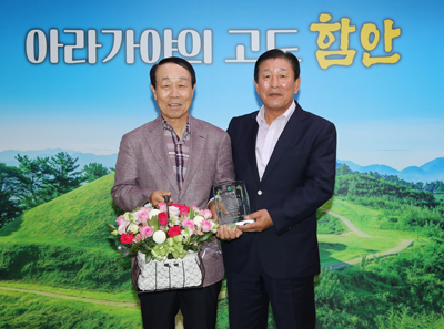 조근제 함안군수가(오른쪽) 지역 최고참 문화관광해설사인 전정렬 씨에게 공로패를 수상하고 기념사진을 촬영하고 있다.