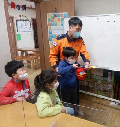 지난해 11월 진해의 지역아동센터에서 진행한 소방안전교육에서 어린이들이 소화기 사용 방법을 체험하고 있다.